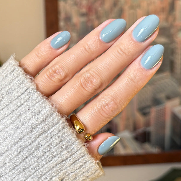 hand with light blue polish